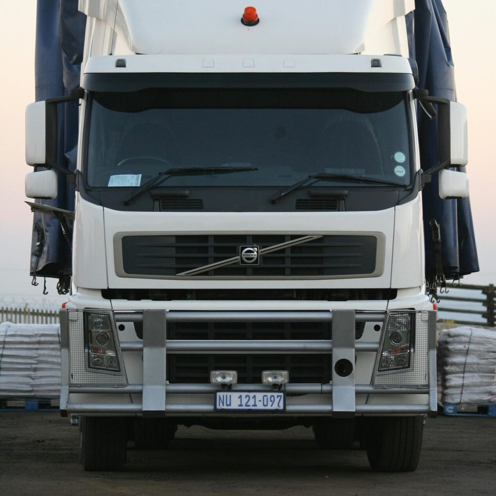 A powerful white truck captured from the front, showcasing its robust design.